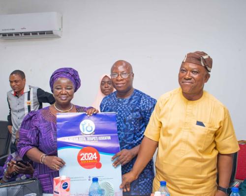 Mrs. M. O. Ojo flagged by executives at the NDTA general meeting Lagos State Chapter during presentation of calendar session.